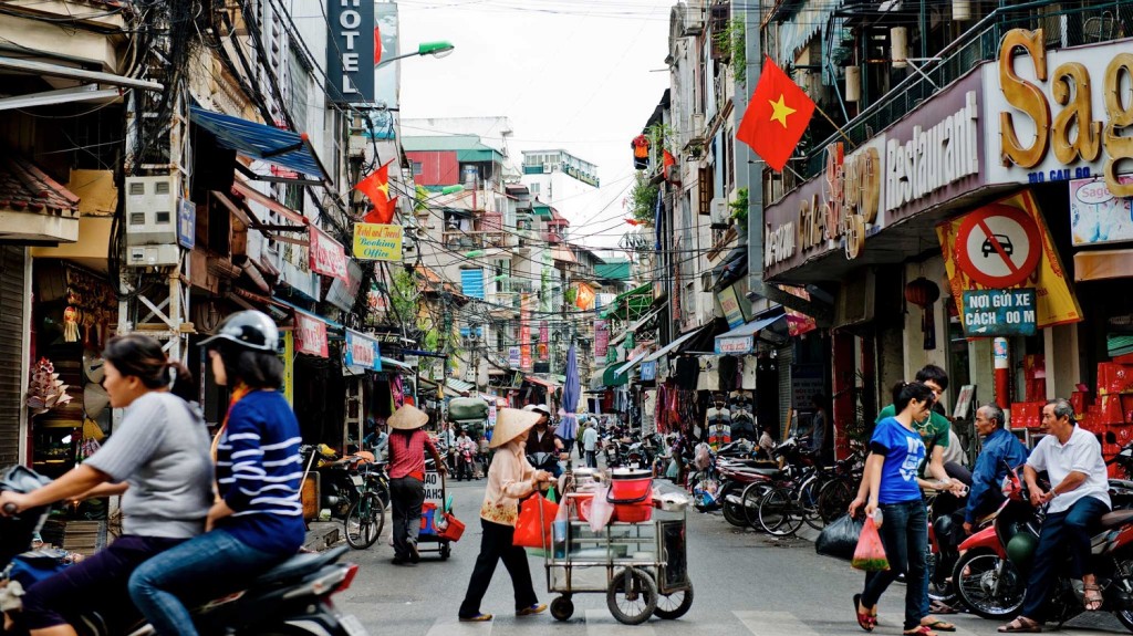 Street vendors push their carts along a side street in Hanoi, Vietnam, on Friday, Sept. 14, 2012. Vietnam has no need for loans from the International Monetary Fund, China, Japan, South Korea or neighbors in the Association of Southeast Asian Nations as the country has taken steps to overhaul its economy and banks, Prime Minister Nguyen Tan Dung said. Photographer: Justin Mott/Bloomberg