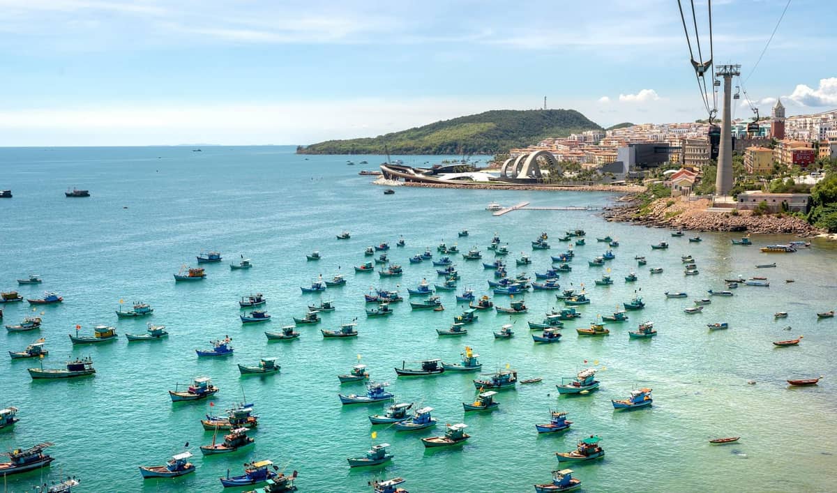 Fishing boats and limestone karsts near a Vietnam island you can visit without permission